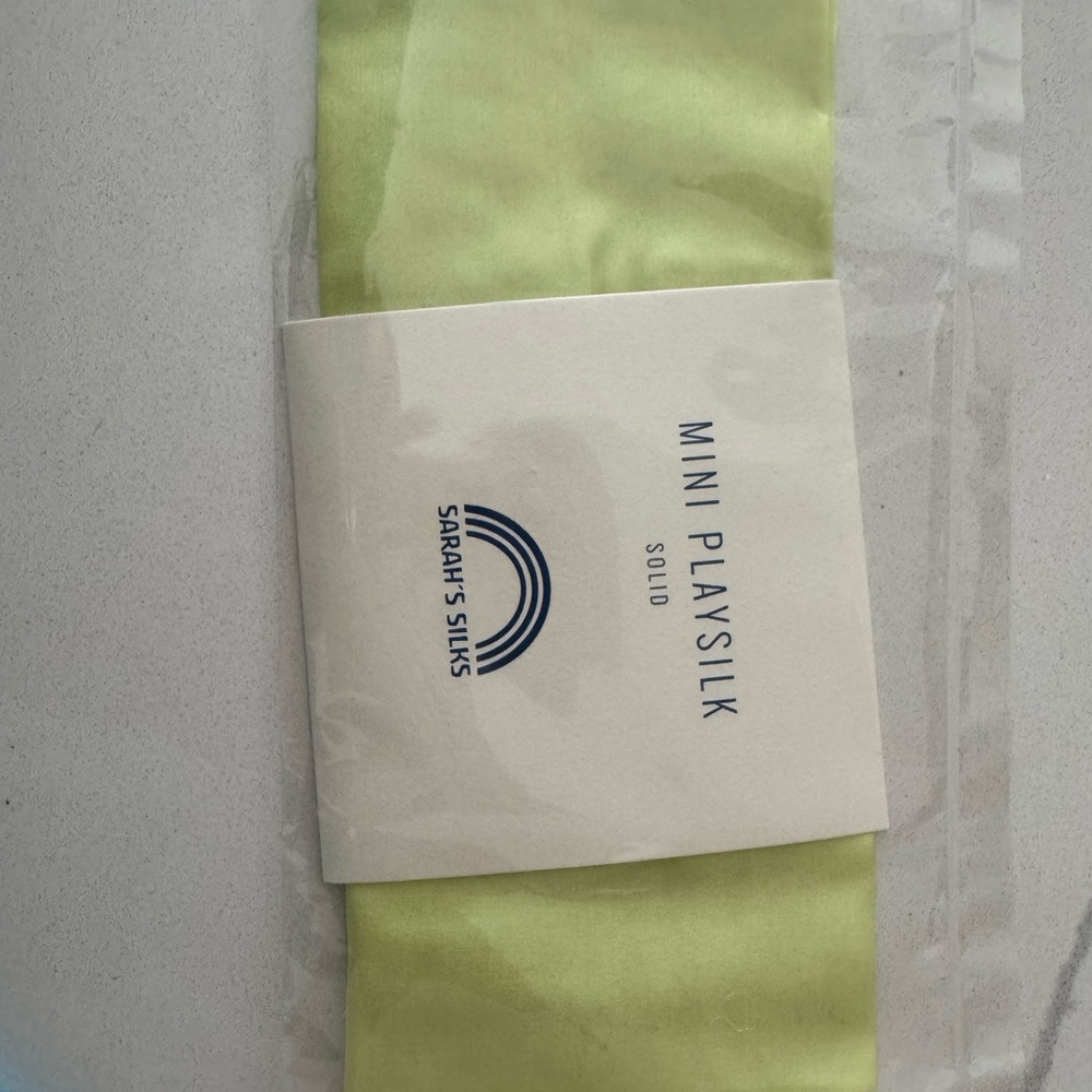 One Sarah’s Silks mini play silk. Lime green